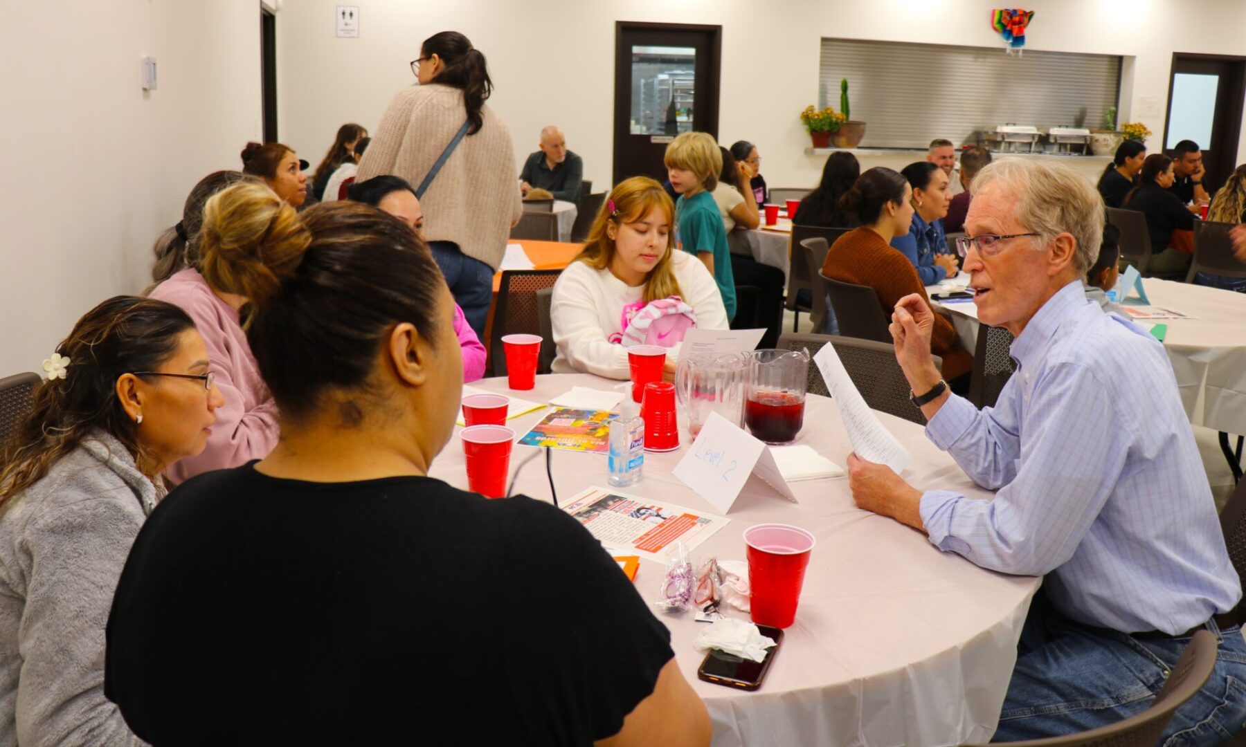 People gathered around a table enjoying a meal and conversation.